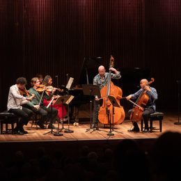 Group of musicians onstage playing instruments