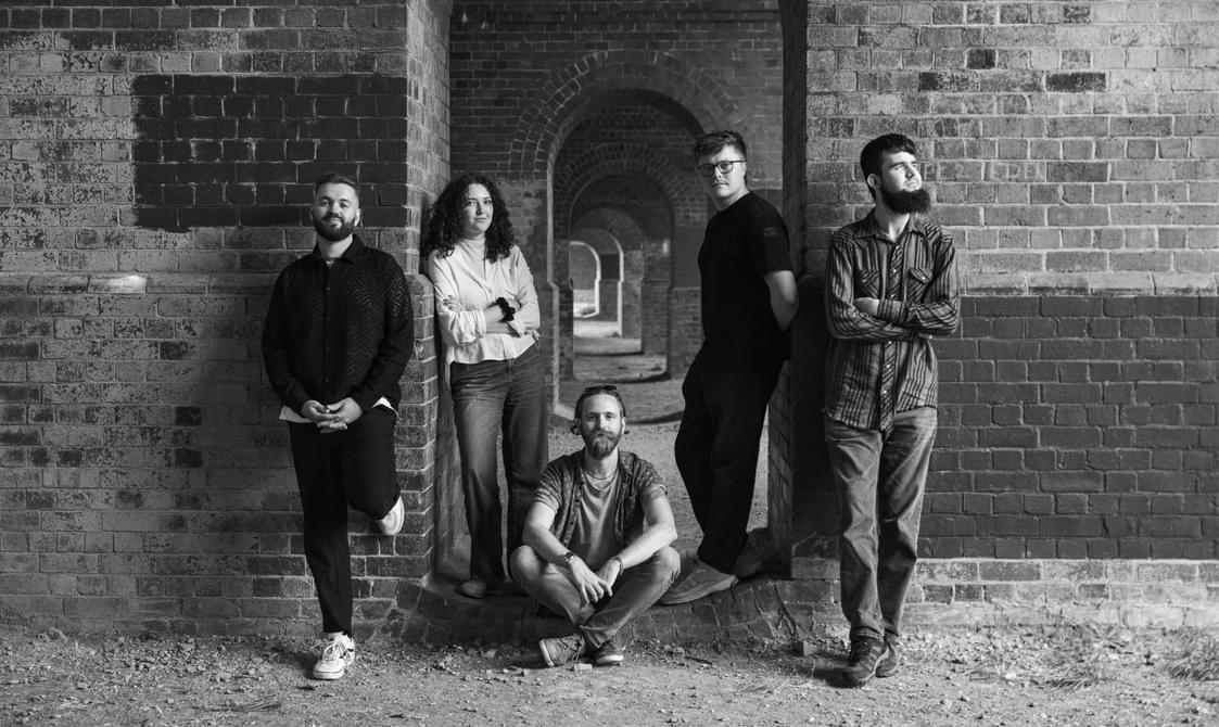 Black and white view of Bonuru group standing in an archway.