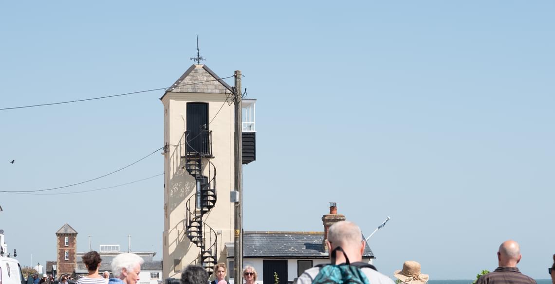 Tall building with exterior winding staircase.