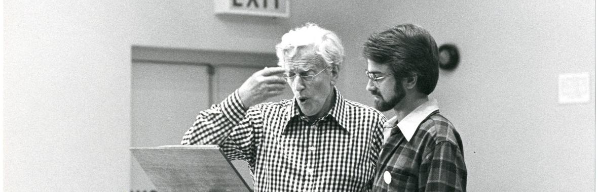 Black and white image of two men teaching singing.