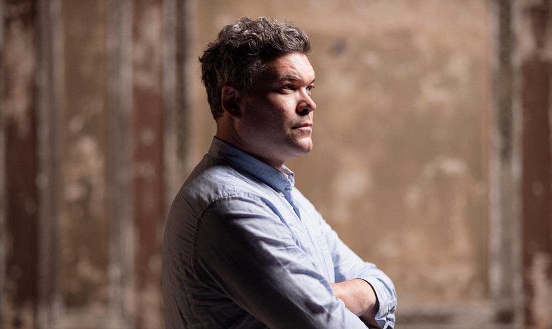 Man with short hair looking to the side