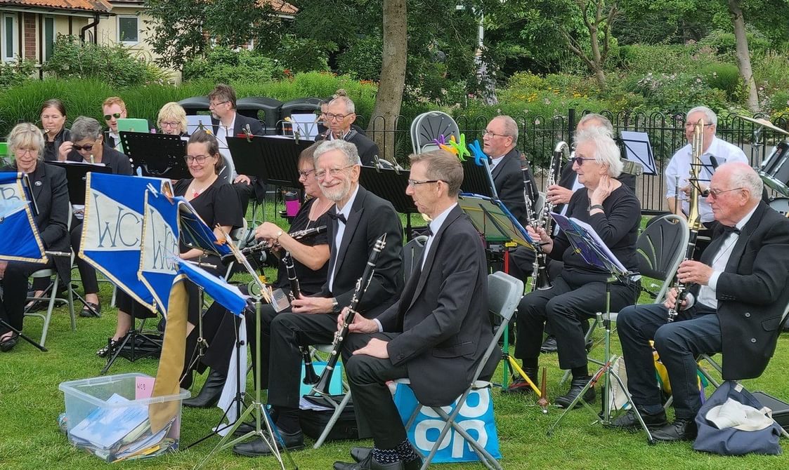 Group of musicians sitting together with their instruments.