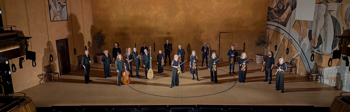 Music group onstage with instruments.