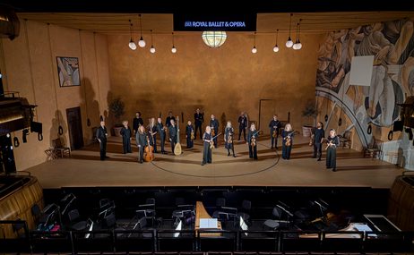 Music group onstage with instruments.