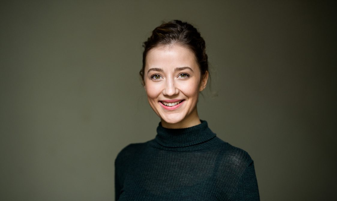 Woman with hair swept back and smiling.