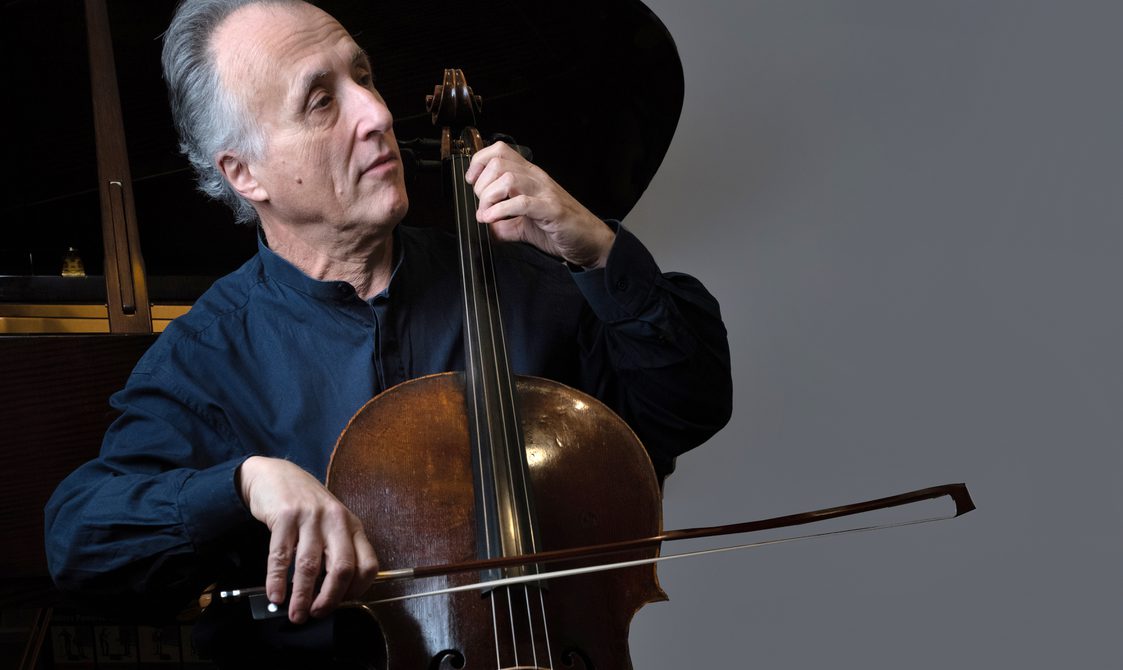 Man with short grey hair playing the cello.