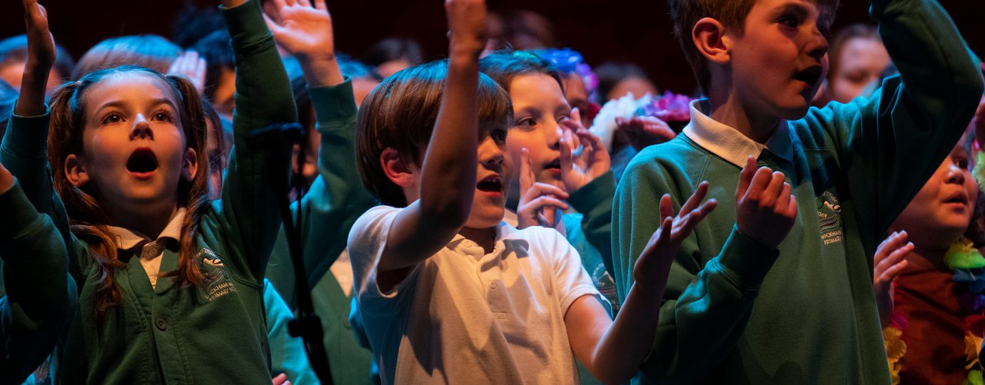 Children singing in school uniforms