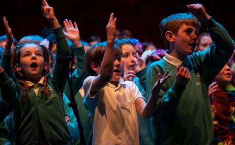 Children singing in school uniforms