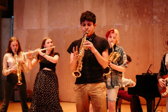 A group of Aldeburgh Young Musicians playing brass instruments
