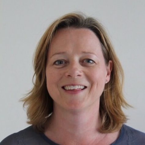 Headshot of Emily smiling at the camera