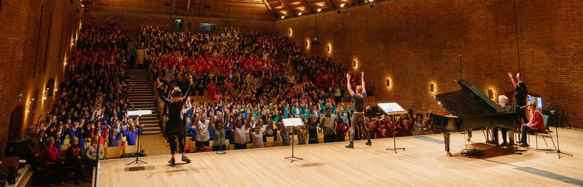 A concert hall full of children singing