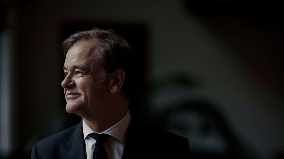 Julius Drake, a man in a suit looking into the distance.