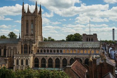 Large cathedral with gothic spires and the city surrounding it.
