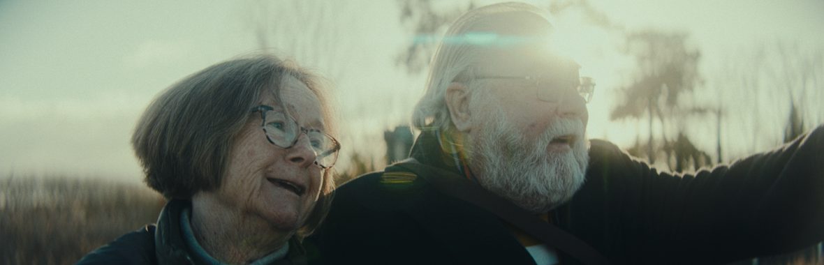 Close up of man and woman looking out at the landscape and smiling