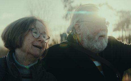 Close up of man and woman looking out at the landscape and smiling