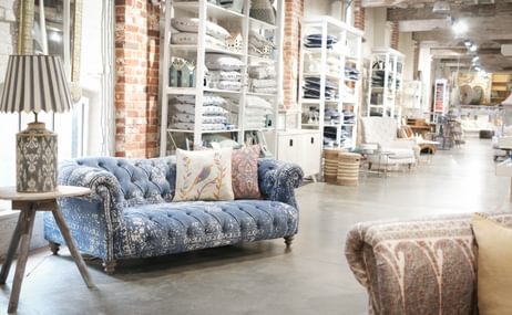 View of shop floor with sofa and lamp on table
