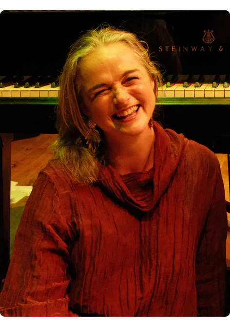 Woman with bobbed blonde hair smiling.