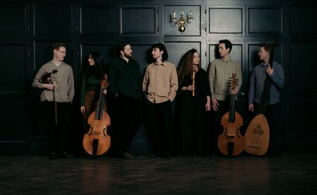 Bellot Ensemble, six musicians standing together with their instruments against a dark background.