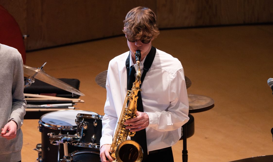 Close-up of boy playing the saxophone