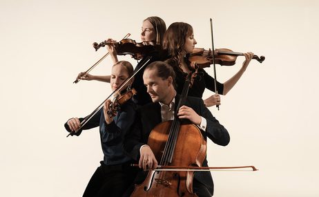 Four musicians playing string instruments, standing in a group against a cream background.