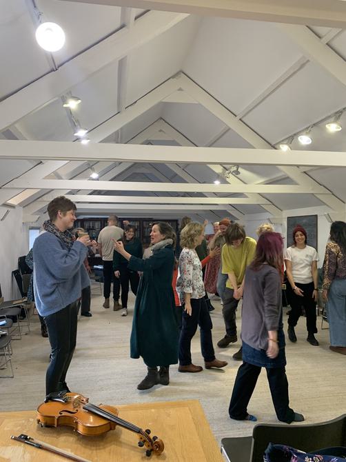 Group of people standing and walking around.