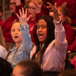 A group of schoolchildren singing.