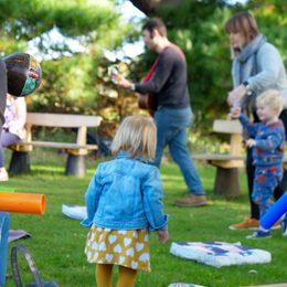 Children accompanied by adults in a garden.