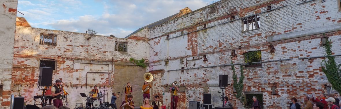 People in a derelict building at Snape Maltings