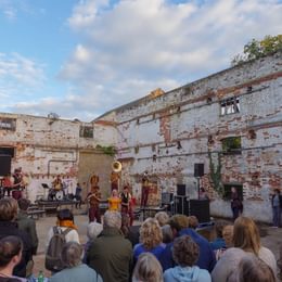 People in a derelict building at Snape Maltings