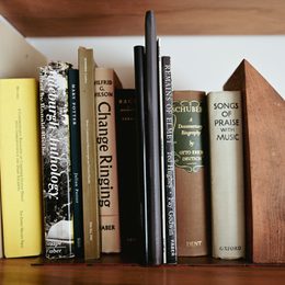 Vintage books arranged on a dark wooden shelf