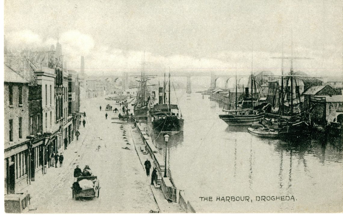 A black and white photograph of a river next to a road in 1953