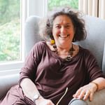 Katherine Zeserson sitting in a chair smiling