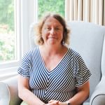 Jo Laverty sitting in a chair smiling