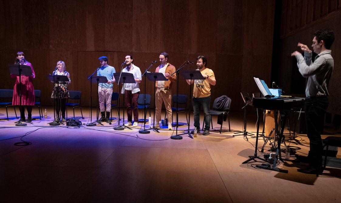 A group of people singong on stage