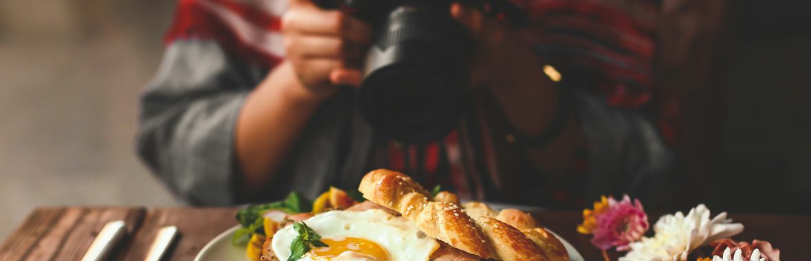 Person taking a photo of food.